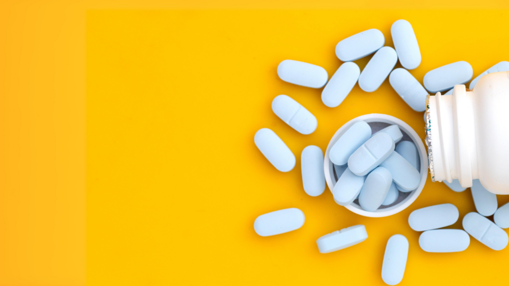 a medicine tablets with a container over a yellow background